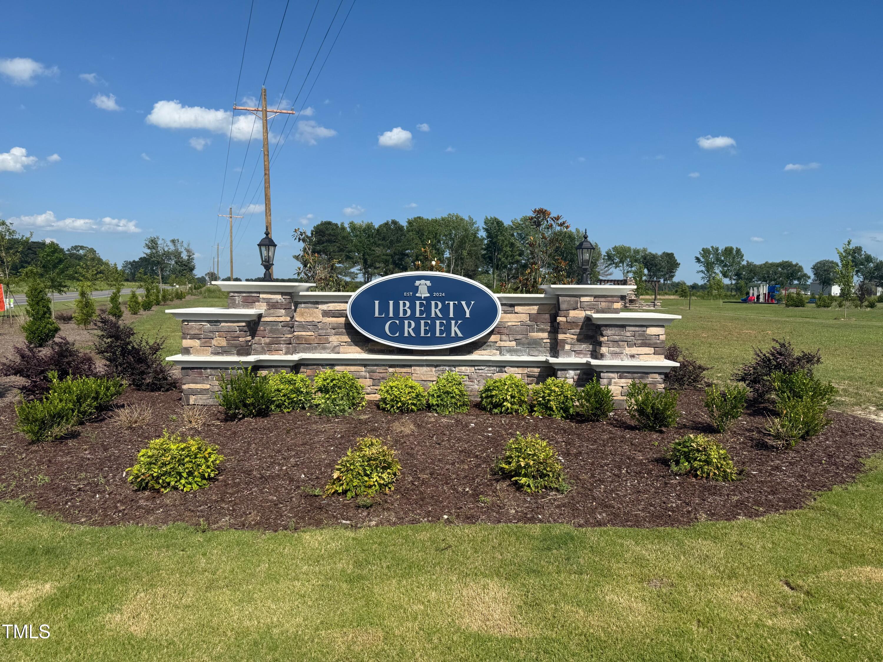 48 Spirit Spgs Road Smithfield, NC 27577 - Photo 23 of 24 a view of a house with a yard and a pond