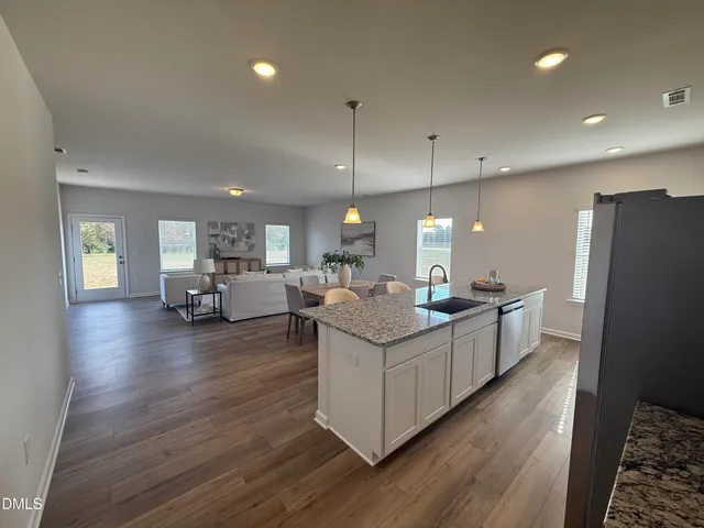 a kitchen with center island attached living room