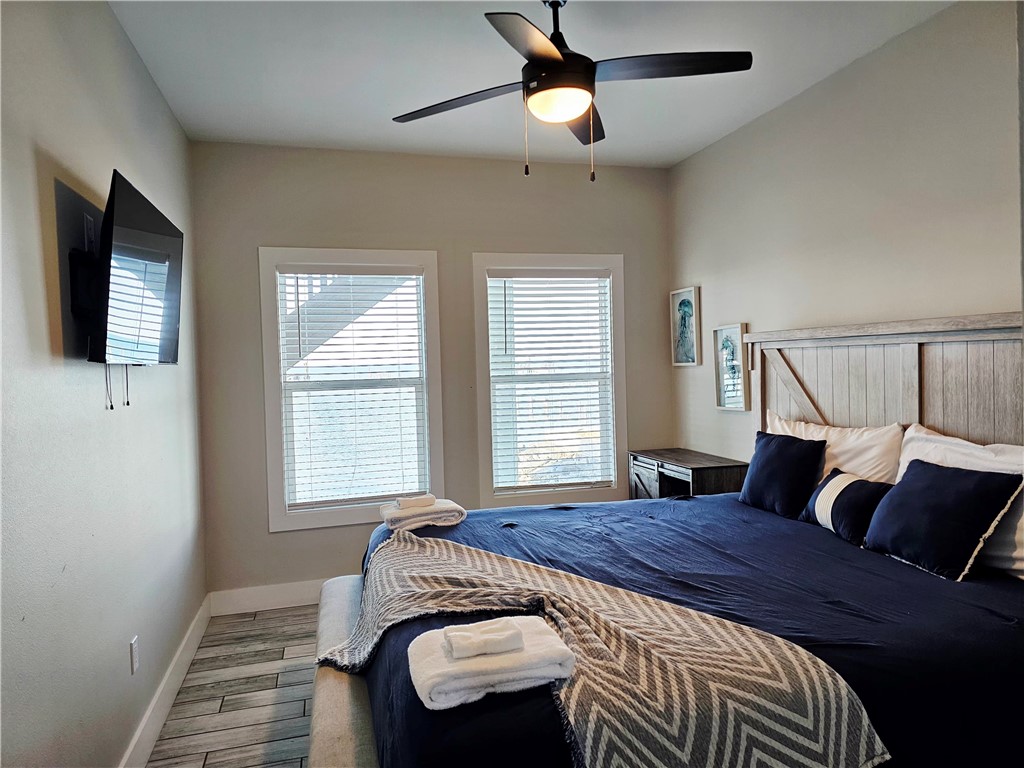 122 Ridge Harbor Drive Rockport, TX 78382 - Photo 29 of 34 a spacious bedroom with a bed and wooden floor