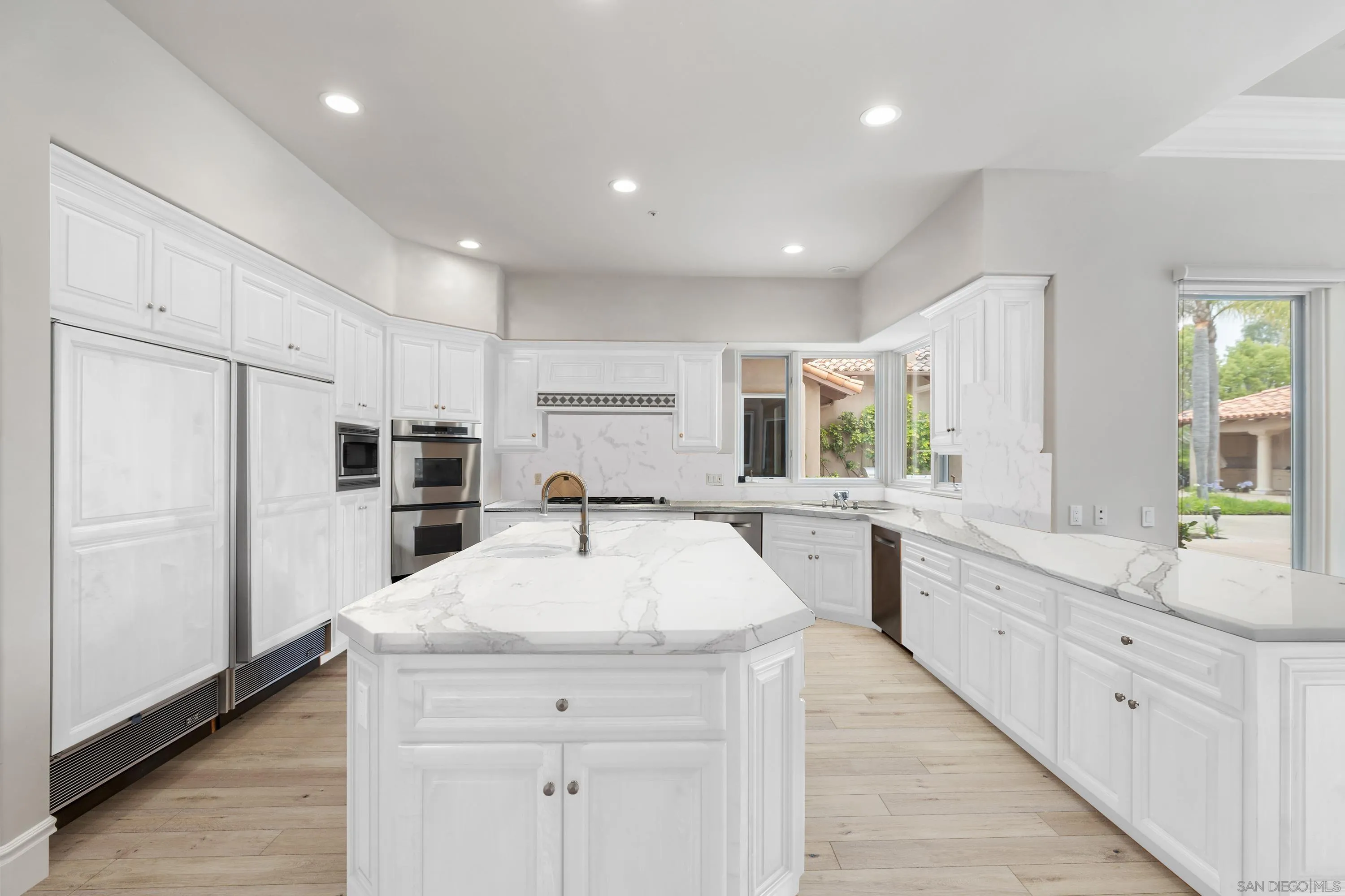 18050 Rancho La Cima Corte Rancho Santa Fe, CA 92067 - Photo 20 of 57 a large kitchen with sink a refrigerator and white cabinets
