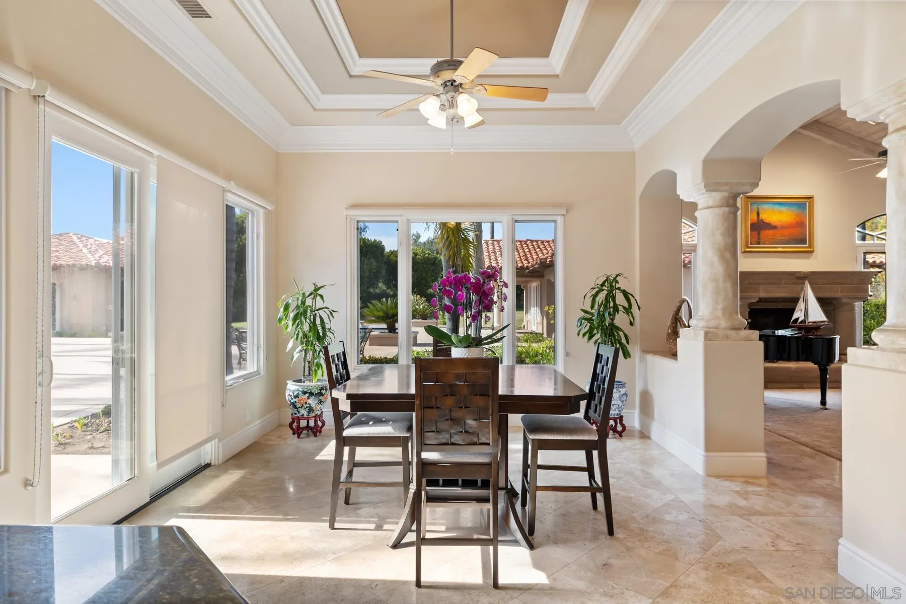 18050 Rancho La Cima Corte Rancho Santa Fe, CA 92067 - Photo 24 of 57 a dining room with furniture potted plants and a chandelier