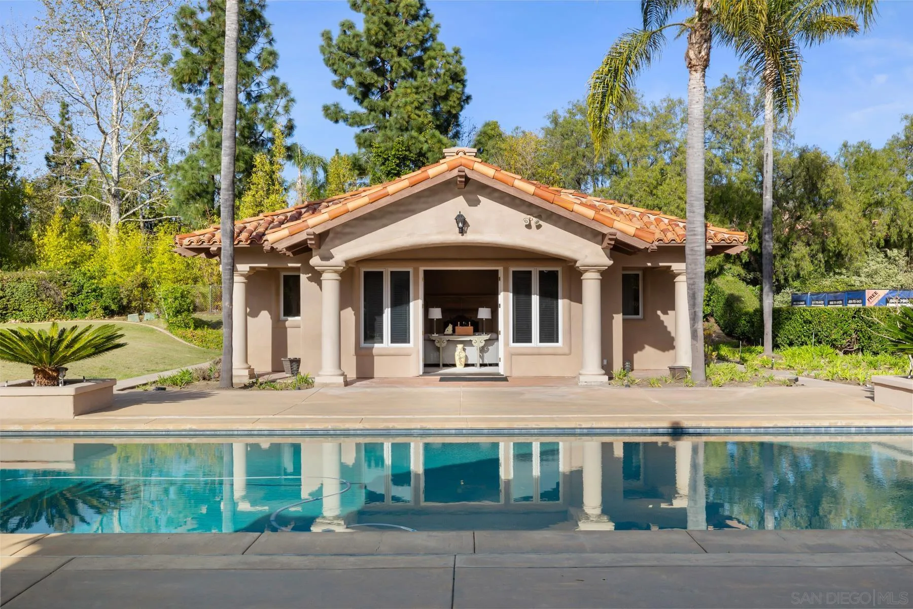 18050 Rancho La Cima Corte Rancho Santa Fe, CA 92067 - Photo 45 of 57 a front view of a house with porch and garden