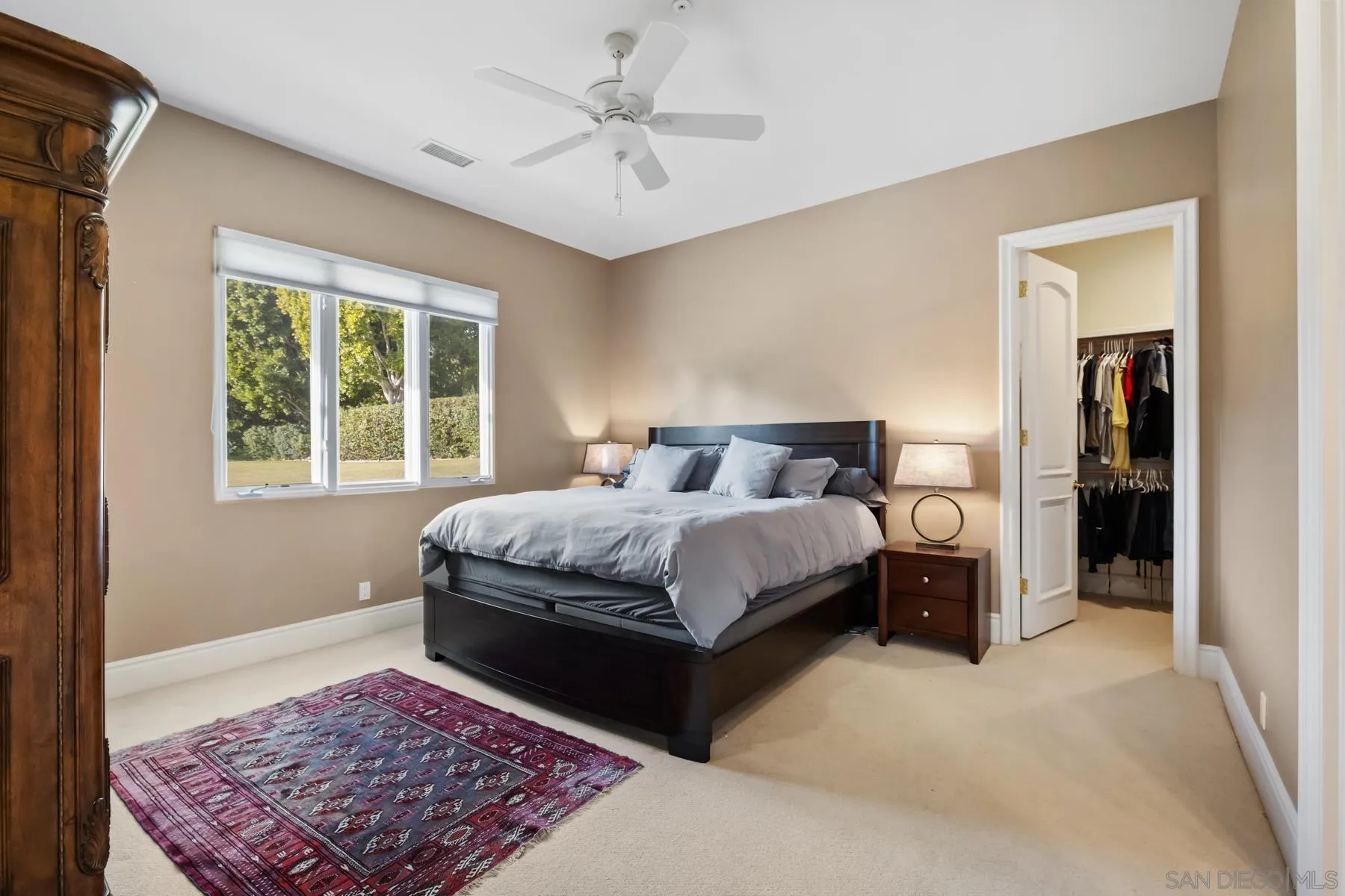 18050 Rancho La Cima Corte Rancho Santa Fe, CA 92067 - Photo 49 of 57 a bedroom with a large bed and a rug