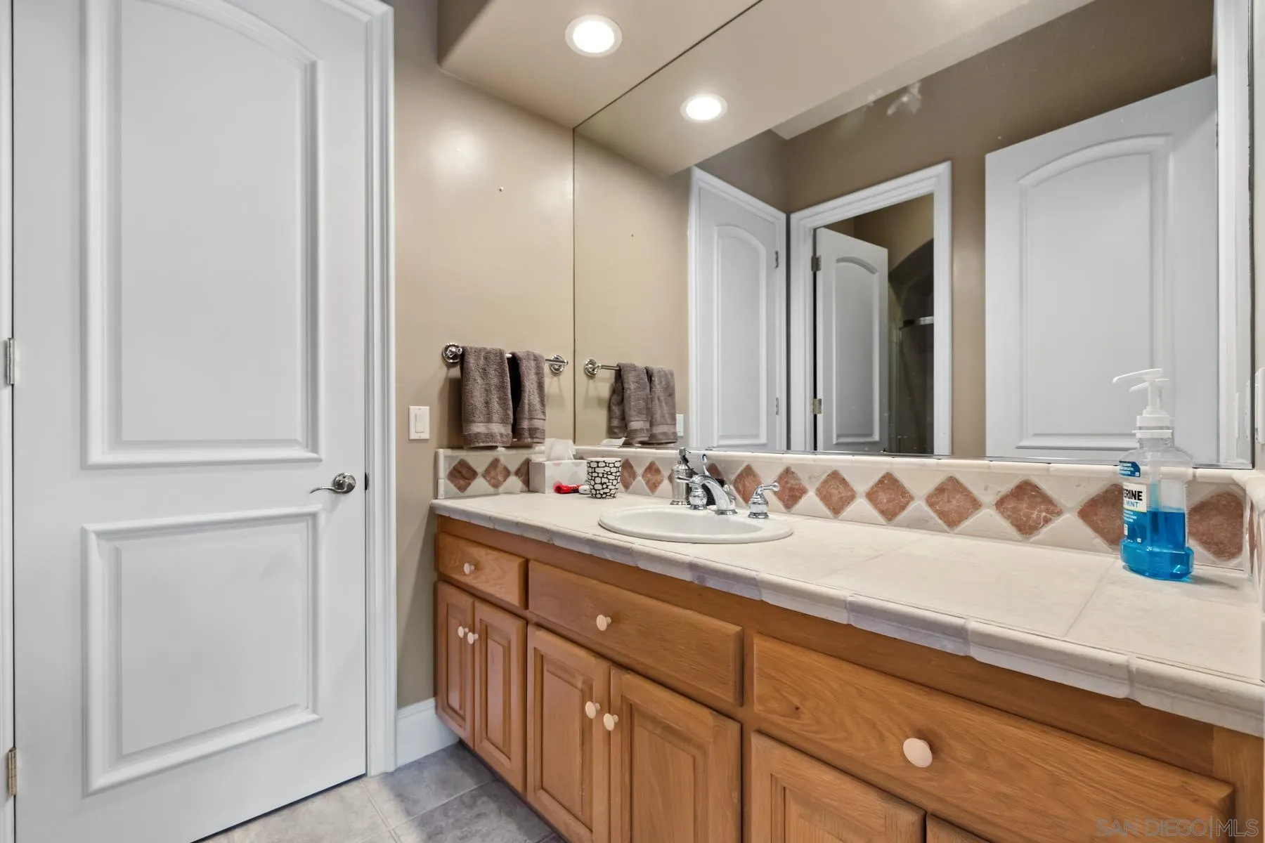 18050 Rancho La Cima Corte Rancho Santa Fe, CA 92067 - Photo 51 of 57 a bathroom with a sink and a mirror