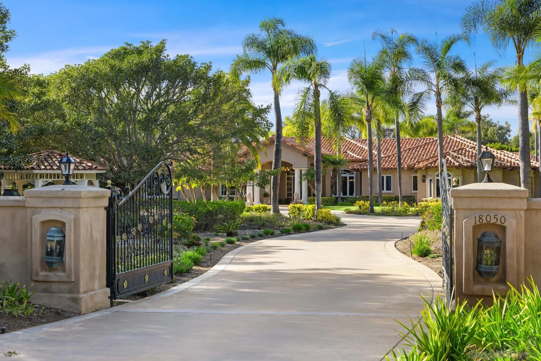 18050 Rancho La Cima Corte Rancho Santa Fe, CA 92067 - Photo 7 of 57 a view of a house with a garden and pathway