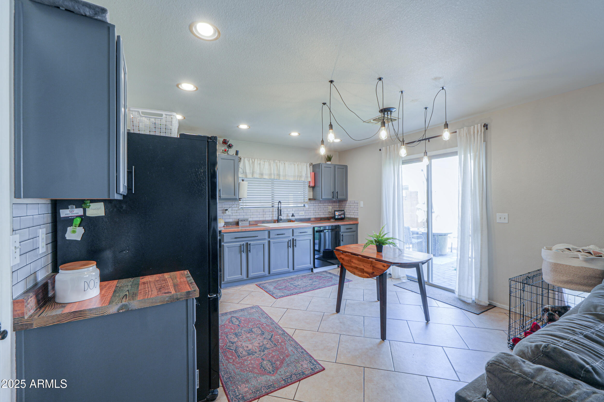 3433 South Chaparral Road Apache Junction, AZ 85119 - Photo 9 of 37 a kitchen with stainless steel appliances kitchen island granite countertop a table and chairs in it