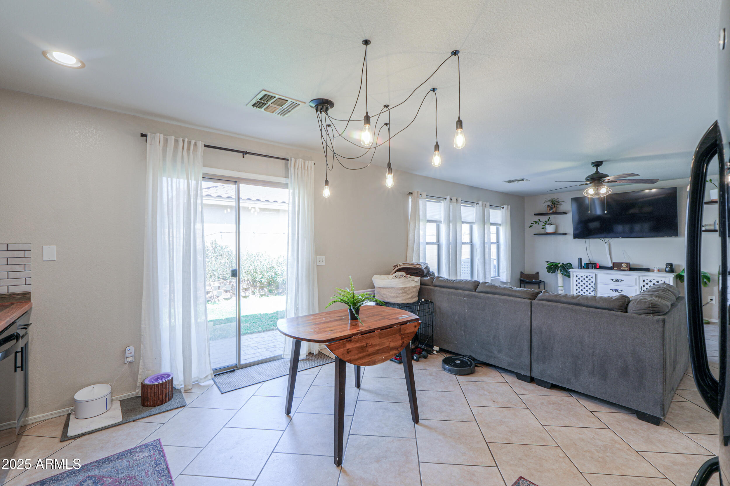 3433 South Chaparral Road Apache Junction, AZ 85119 - Photo 10 of 37 a kitchen with stainless steel appliances kitchen island granite countertop a refrigerator a sink a dining table and chairs with the view of kitchen