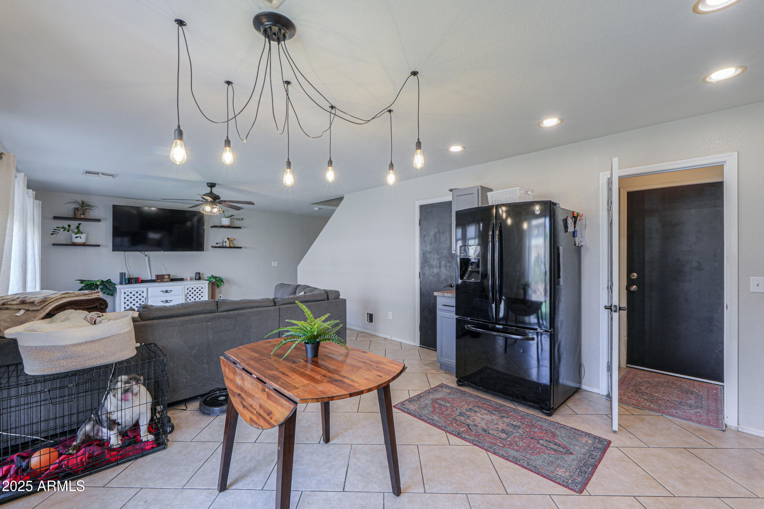 3433 South Chaparral Road Apache Junction, AZ 85119 - Photo 11 of 37 a kitchen with stainless steel appliances kitchen island granite countertop a refrigerator a stove a sink and a dining table with white cabinets