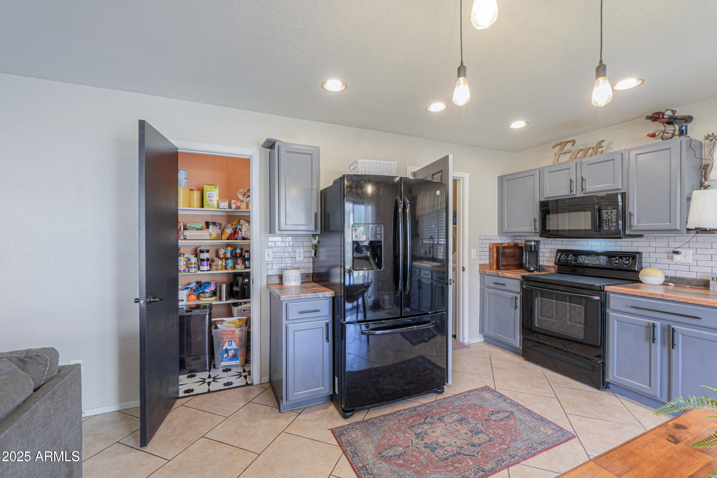 3433 South Chaparral Road Apache Junction, AZ 85119 - Photo 13 of 37 a kitchen with stainless steel appliances granite countertop a refrigerator and a stove top oven