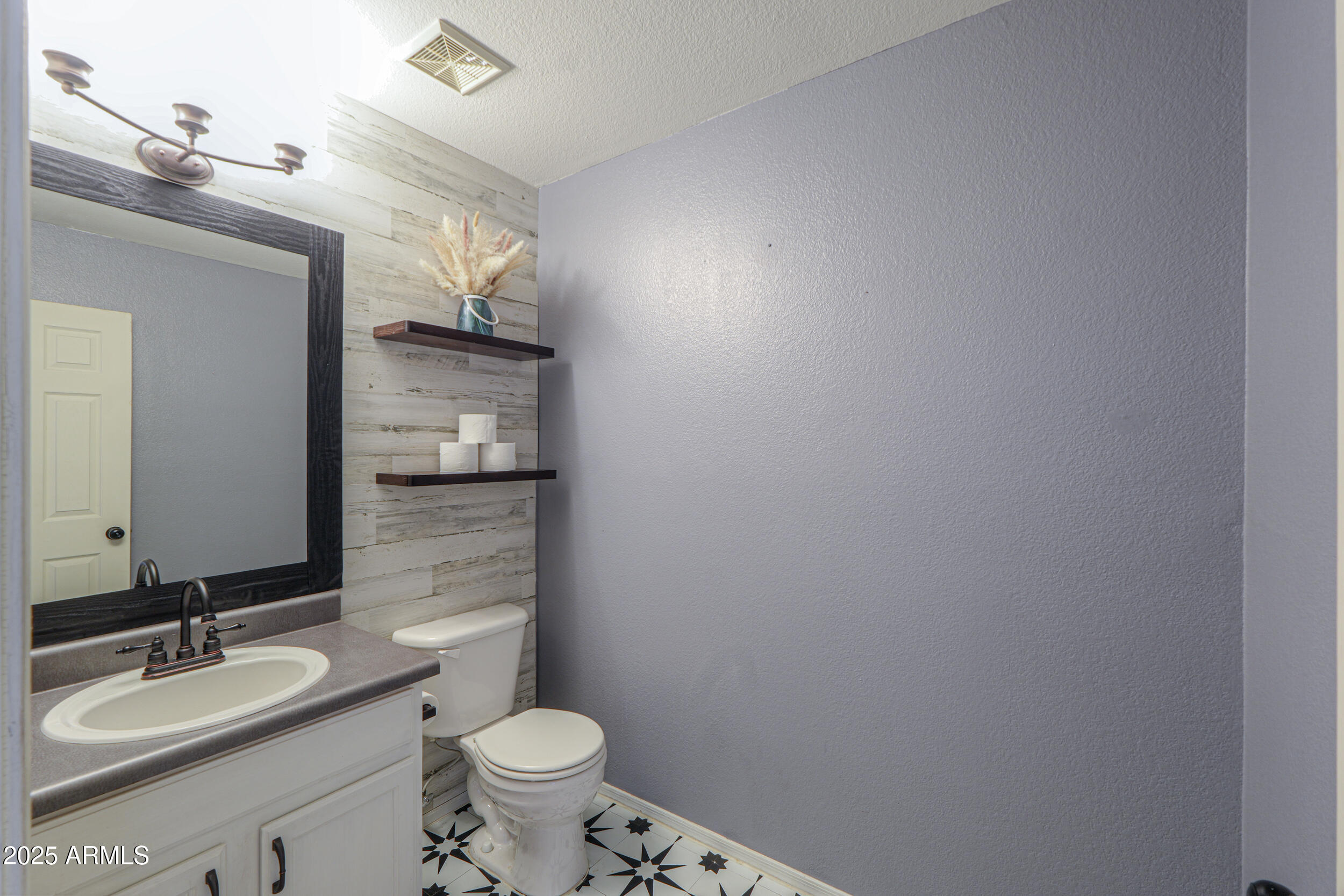 3433 South Chaparral Road Apache Junction, AZ 85119 - Photo 15 of 37 a bathroom with a granite countertop sink a toilet and a mirror