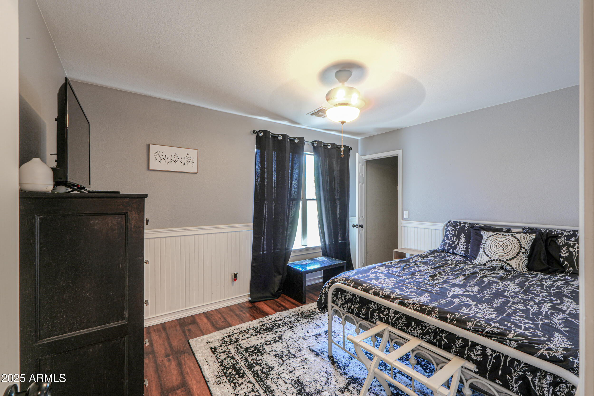 3433 South Chaparral Road Apache Junction, AZ 85119 - Photo 24 of 37 a bedroom with a large bed and a chandelier