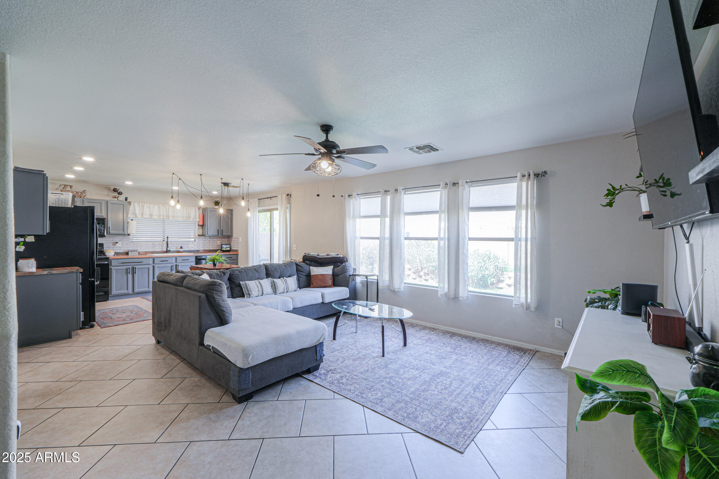 3433 South Chaparral Road Apache Junction, AZ 85119 - Photo 3 of 37 a living room with furniture and a large window