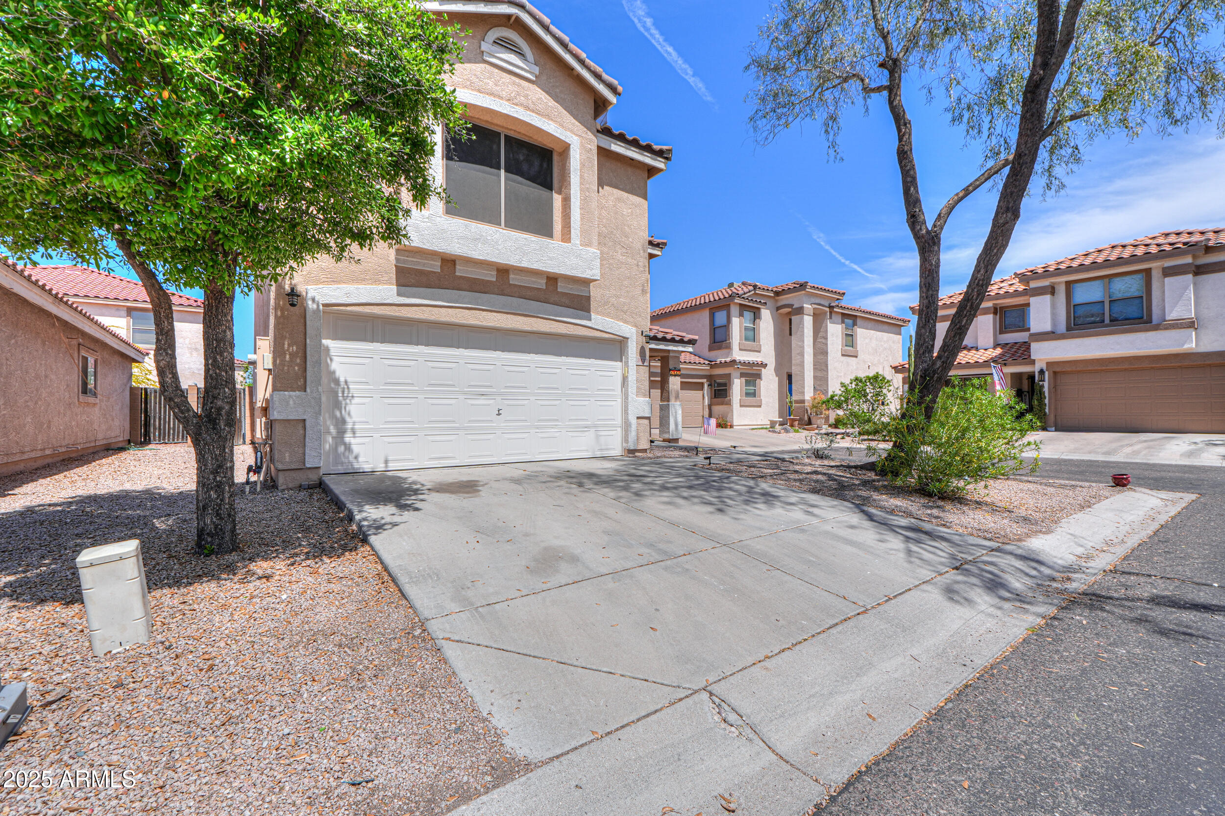 3433 South Chaparral Road Apache Junction, AZ 85119 - Photo 4 of 37 a view of a white house with a large tree and a yard