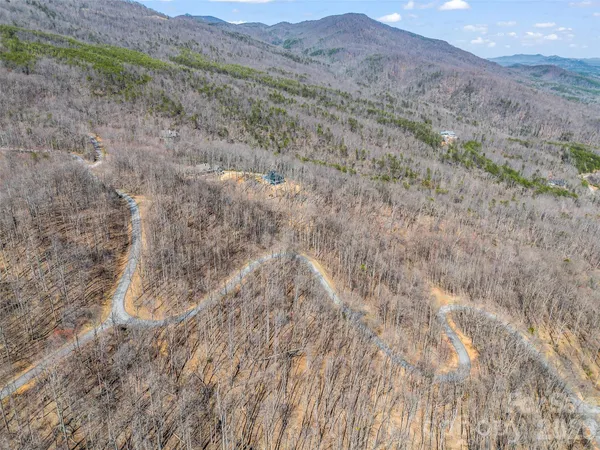 a view of a dry yard with mountains in the background