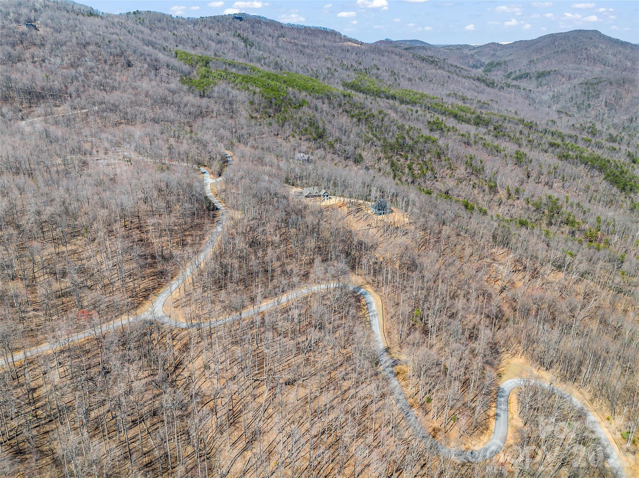 183 Chesterfield Drive, Unit 183 Mill Spring, NC 28756 - Photo 12 of 35 a view of a dry field with mountains in the background