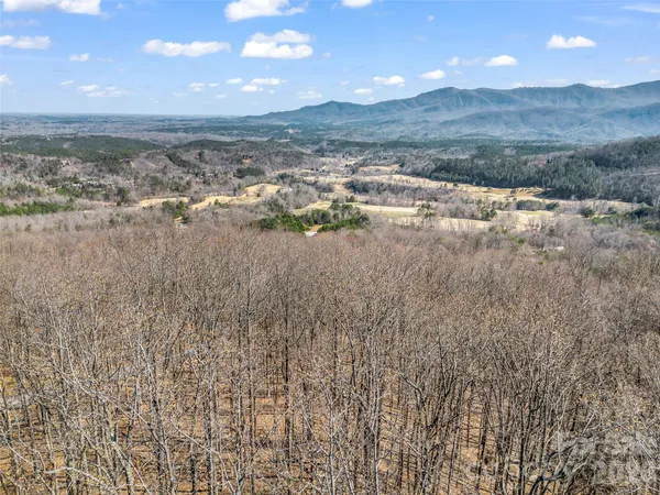 an aerial view of a house with swimming pool garden and outdoor seating