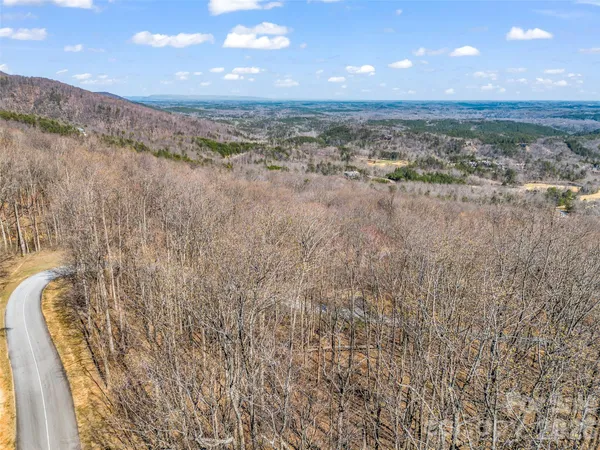a backyard of a house with yard table and chairs
