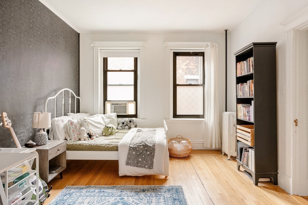 111 Jersey Street, Unit 12 Boston, MA 02215 - Photo 14 of 17 a bedroom with furniture and a book shelf