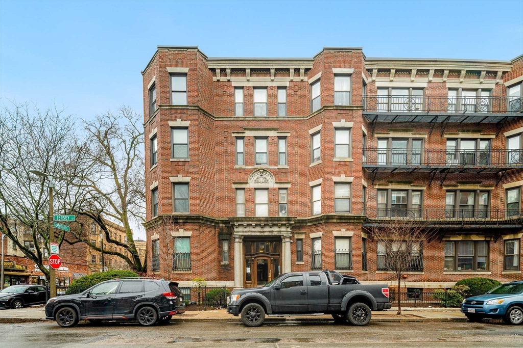 111 Jersey Street, Unit 12 Boston, MA 02215 - Photo 16 of 17 a car parked in front of a big building