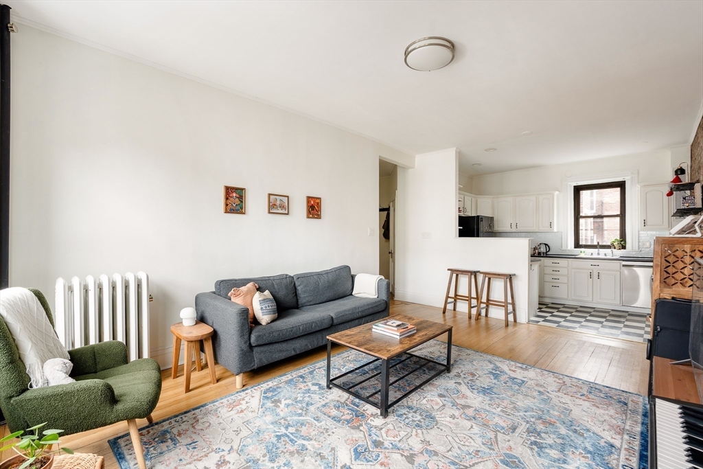 111 Jersey Street, Unit 12 Boston, MA 02215 - Photo 4 of 17 a living room with furniture and wooden floor