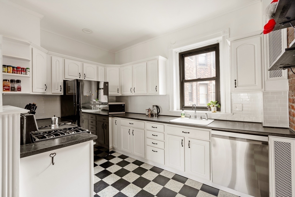 111 Jersey Street, Unit 12 Boston, MA 02215 - Photo 5 of 17 a kitchen with granite countertop a sink stove and cabinets