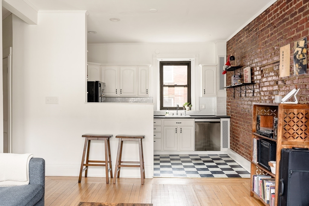 111 Jersey Street, Unit 12 Boston, MA 02215 - Photo 6 of 17 a kitchen with granite countertop a stove a sink and a microwave