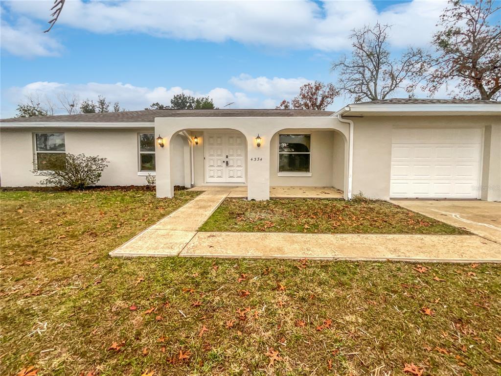 4334 Southwest 148th Street Ocala, FL 34473 - Photo 1 of 1 a front view of a house with a yard