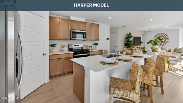 a dining hall with stainless steel appliances granite countertop a stove a sink dishwasher and a microwave oven with wooden floor