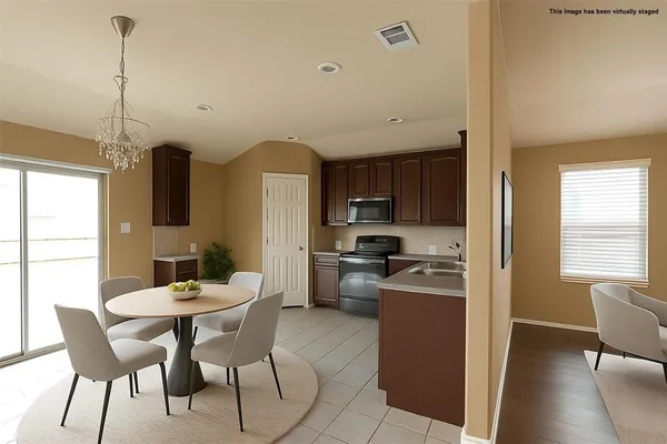 a large kitchen with cabinets and stainless steel appliances