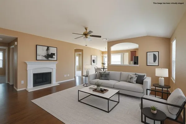 an empty room with windows and fireplace