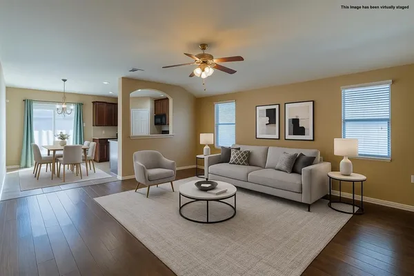 a dining room with furniture and wooden floor