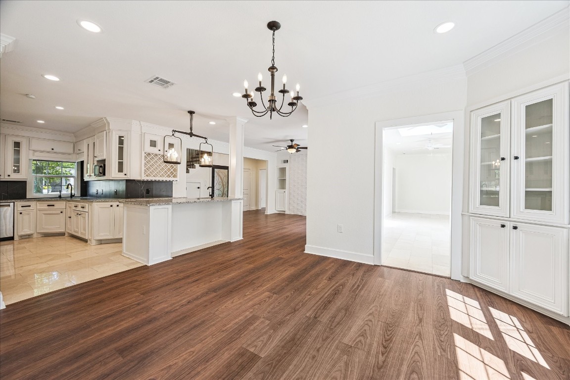 3071 Locke Lane Houston, TX 77019 - Photo 19 of 44 A charming space with built-in shelving, recessed can lighting, and soft neutral walls, offering a warm and functional area for dining. Its open layout connects seamlessly to the kitchen and sunroom.
