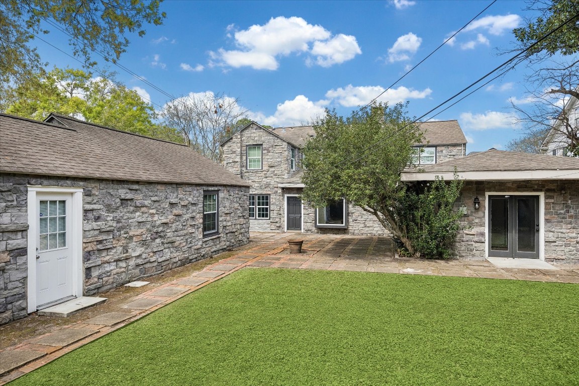 3071 Locke Lane Houston, TX 77019 - Photo 2 of 44 The backyard offers a spacious outdoor area with plenty of room for entertaining, play, or future landscaping. Large windows and French doors from the home provide easy access and a seamless connection to the outdoors.