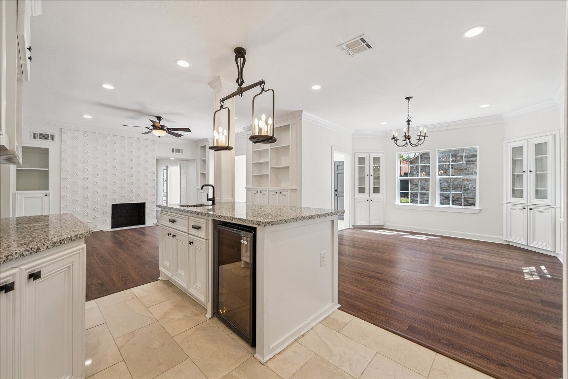3071 Locke Lane Houston, TX 77019 - Photo 21 of 44 The kitchen opens seamlessly to the breakfast room, creating a bright, inviting space perfect for casual dining and entertaining. Granite countertops, an island with breakfast bar seating, and stainless steel appliances complete this functional and stylish layout.