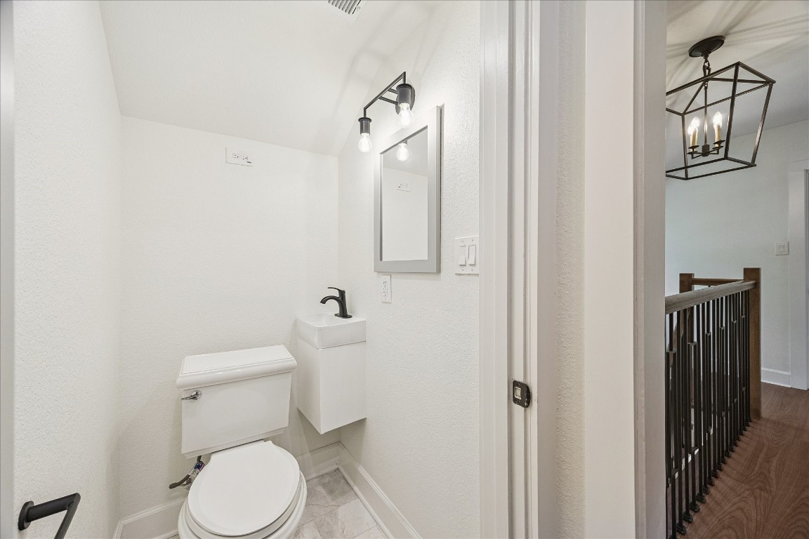 3071 Locke Lane Houston, TX 77019 - Photo 38 of 44 A compact and functional powder bath with sink, tiled flooring, and vanity lighting, combining modern style and efficiency in a small but well-appointed space.
