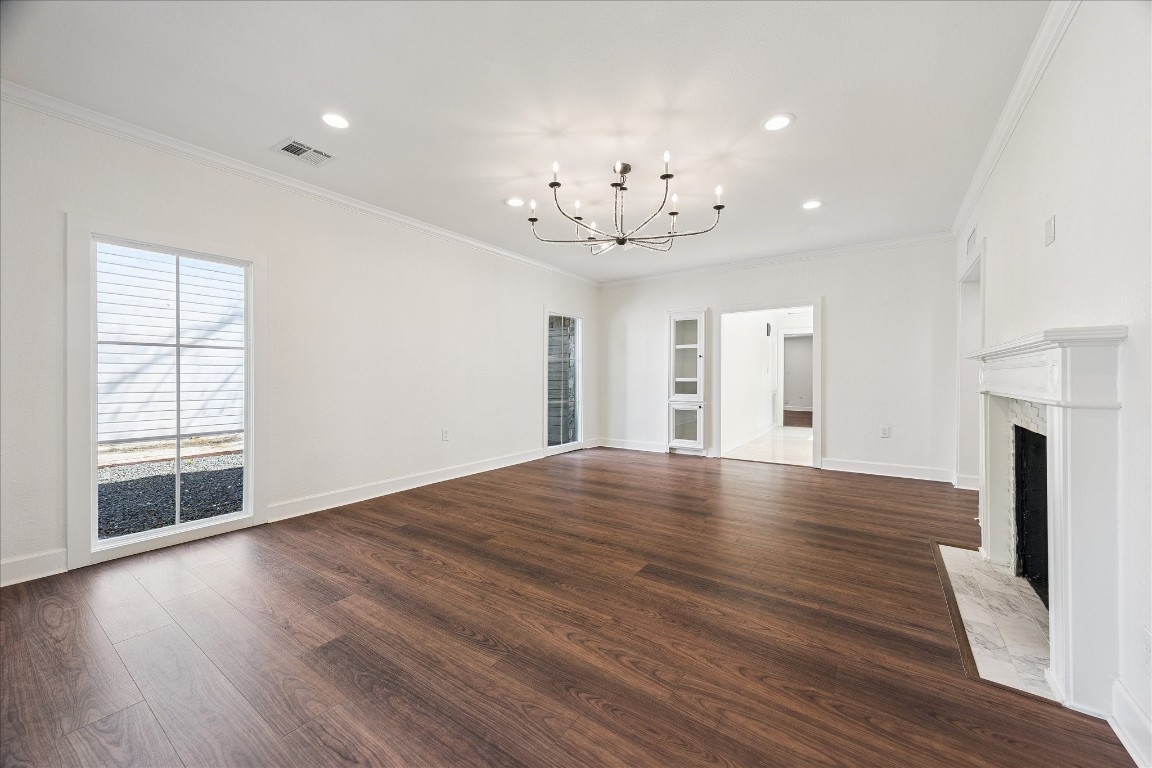 3071 Locke Lane Houston, TX 77019 - Photo 6 of 44 Appointed with laminate wood floors and elegant crown molding, the dining room is highlighted by a designer chandelier and recessed lighting. North- and east-facing windows provide soft natural light, and the seamless flow into the family room creates a warm, inviting setting.