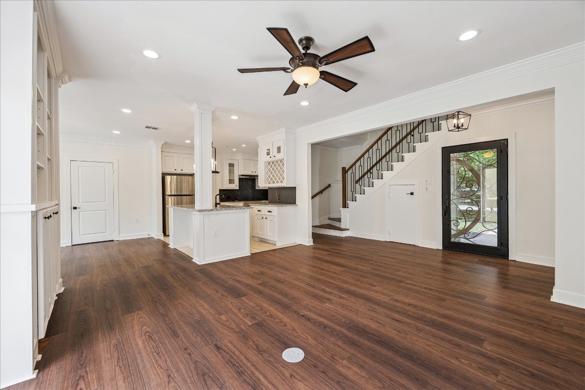 3071 Locke Lane Houston, TX 77019 - Photo 8 of 44 Bright and welcoming, the family room offers easy access to the kitchen, sunroom, and dining room. Neutral designer paint, custom-tiled fireplace, ceiling fan, built-in cabinetry, and crown molding create a sophisticated yet comfortable gathering space.