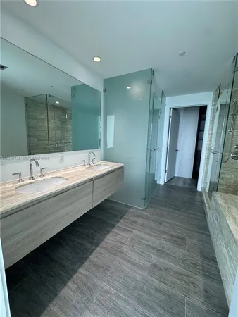 a spacious bathroom with a double vanity sink and a mirror