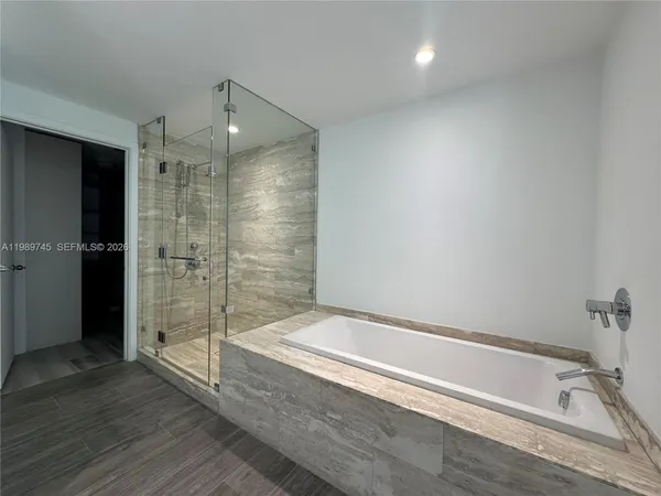 a bathroom with a bathtub and a shower