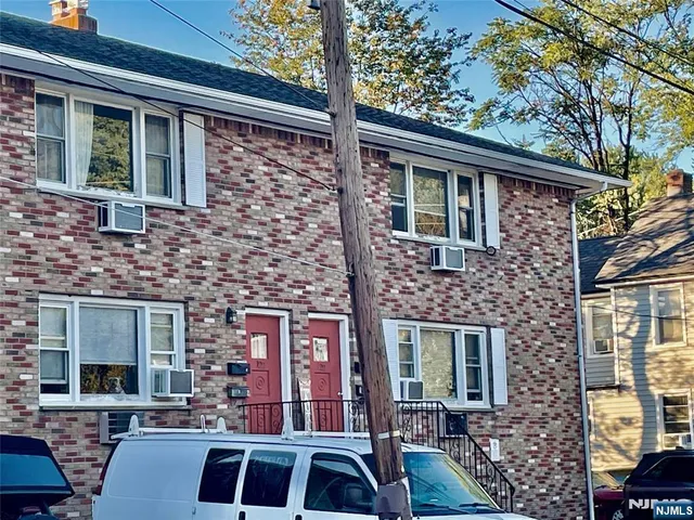 a front view of a house with parking space