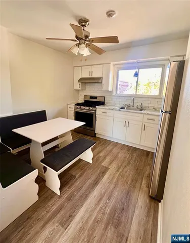 a kitchen with a sink appliances and cabinets
