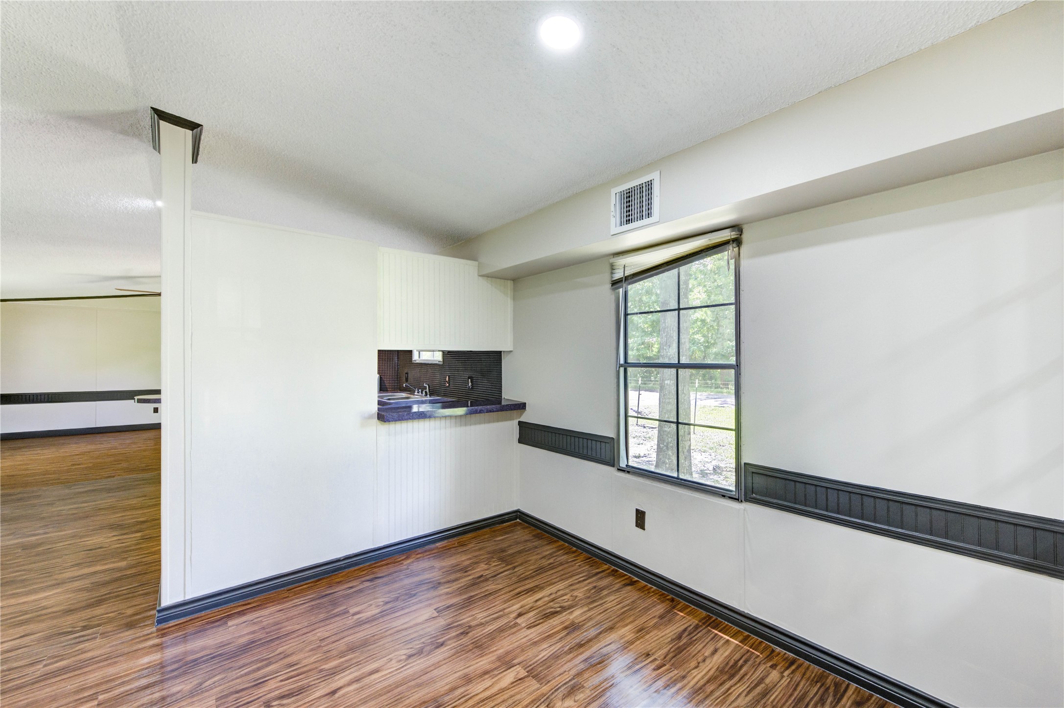 26342 Hunters Trail New Caney, TX 77357 - Photo 13 of 26 a view of empty room with wooden floor and fan