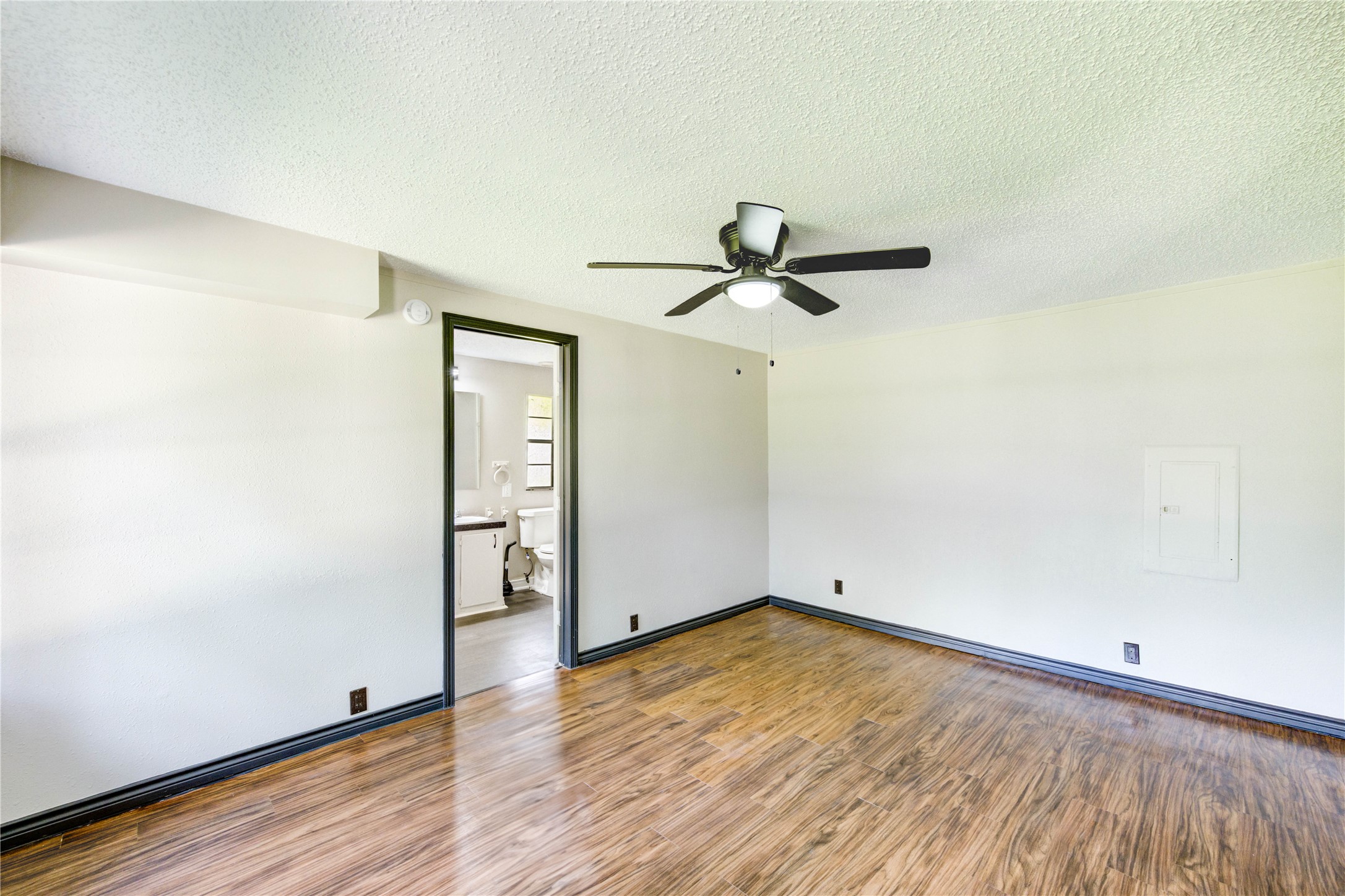 26342 Hunters Trail New Caney, TX 77357 - Photo 15 of 26 an empty room with wooden floor cabinet and windows