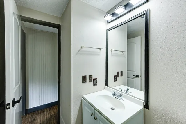 a bathroom with a sink a mirror and a shower
