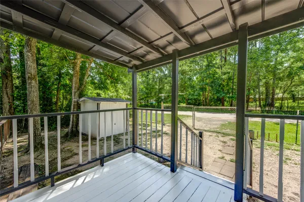 a view of a balcony with wooden floor