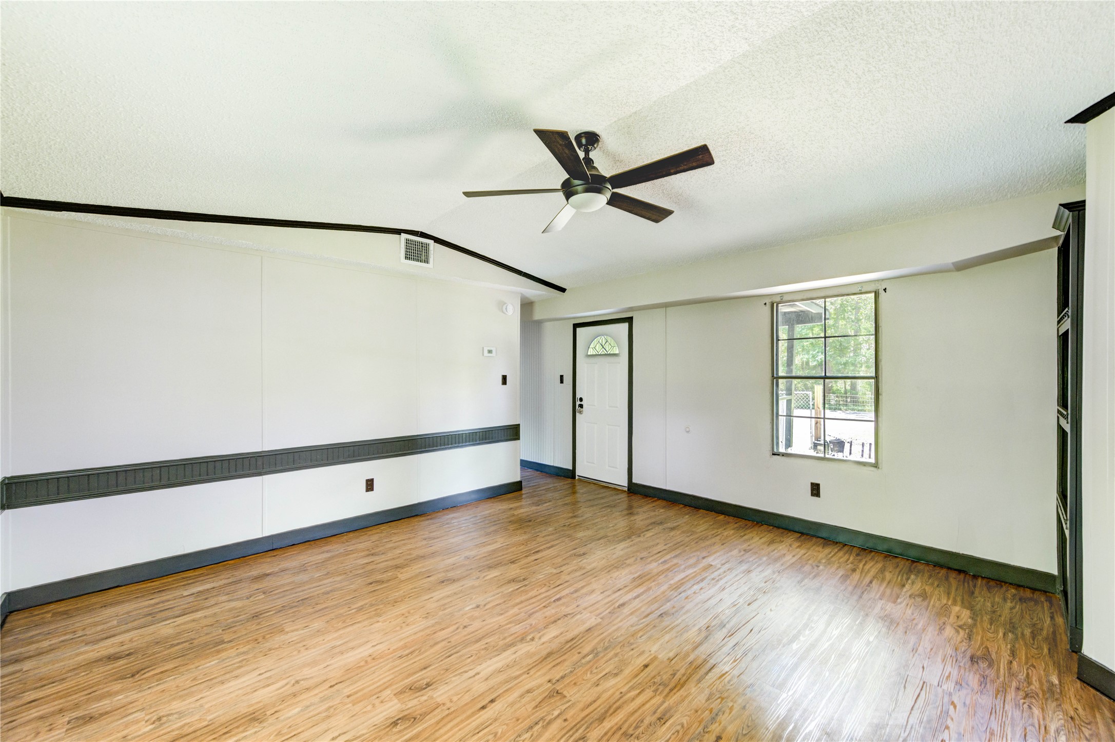 26342 Hunters Trail New Caney, TX 77357 - Photo 7 of 26 a view of an empty room with window and a ceiling fan