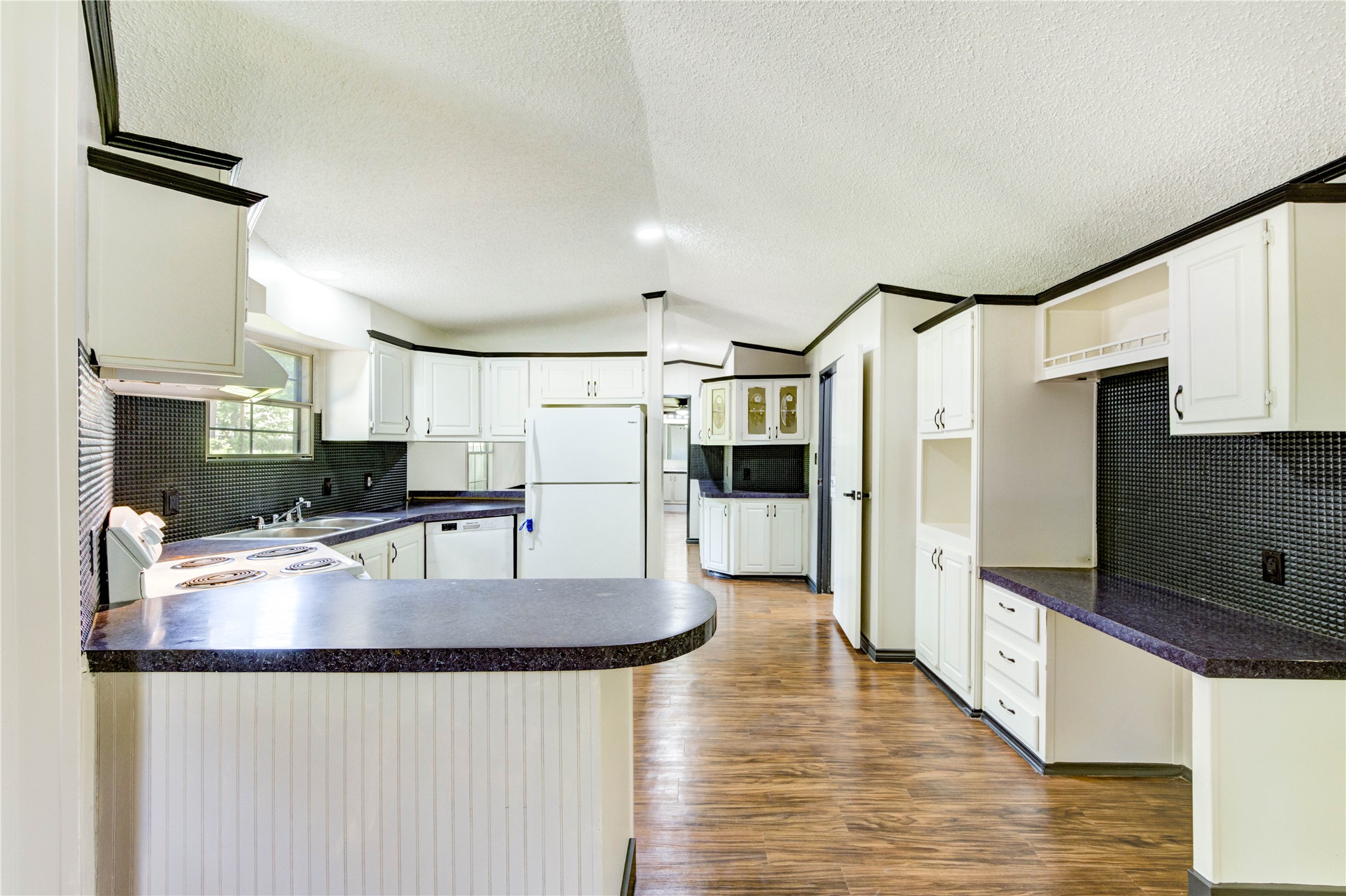 26342 Hunters Trail New Caney, TX 77357 - Photo 8 of 26 a kitchen with stainless steel appliances granite countertop a refrigerator a stove and a sink with wooden floor
