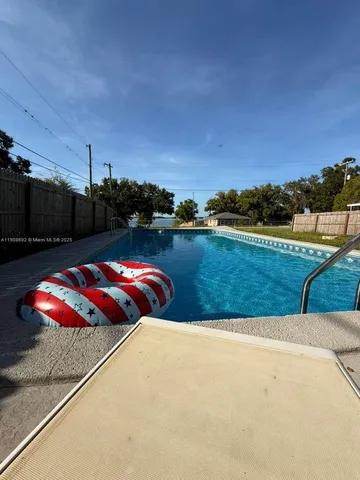 a view of swimming pool with a yard
