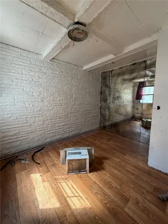 a view of a room with wooden floor