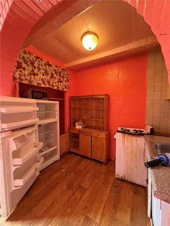 a view of a room with wooden floor